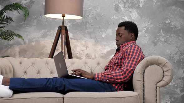 African American Businessman Works Laptop Online Chatting with Company Employees alt