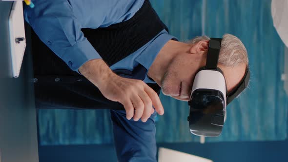 Vertical Video Retired Man Experiencing Virtual Reality Using Vr Headset in Living Room alt