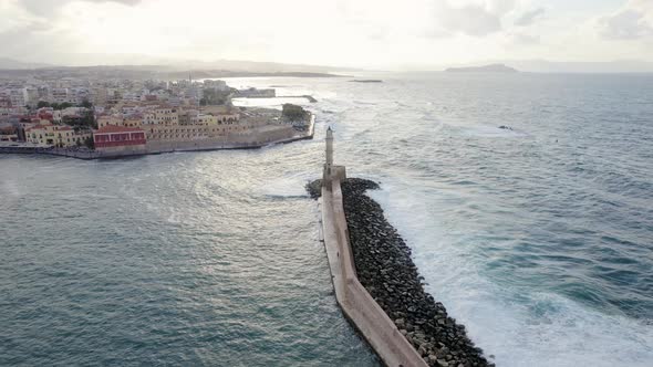Cinematic Aerial Drone sunset shot of lighthouse in the old Venetian port of Chania alt