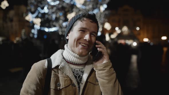 A Man Congratulating Someone on Phone at Xmas Night alt