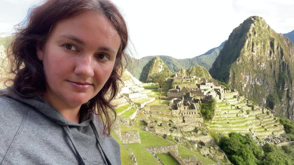 Woman Tourist Making Selfie in the Old Inca Machu Picchu Town in Mountains