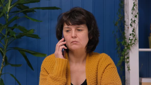 Middle Aged Woman Hears Bad News on the Phone and Shocked