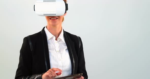 Business woman using virtual reality headset and digital tablet alt
