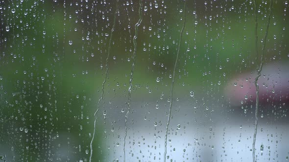 Raining on Window Glass Close Up