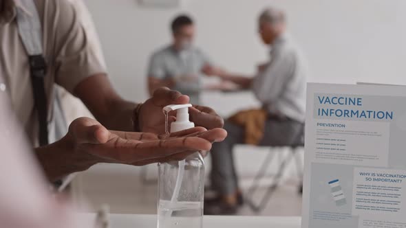 Using Hand Sanitizer in Vaccination Center alt