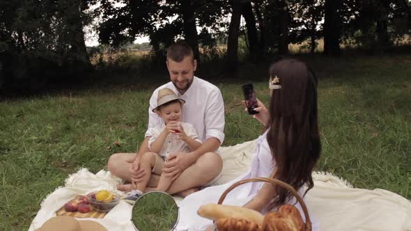 Female Taking Photos of Her Spouse and Son