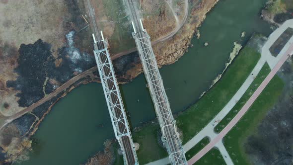 Top down view of modern railway bridge. Empty straight railways across river alt