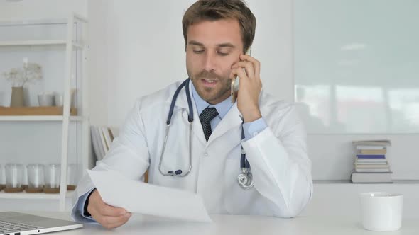 Doctor Attending Phone Call of Patient Discussing Health alt