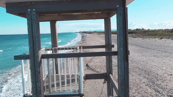 Drone flying through a wood structure in a beach (Valencia, Spain) alt