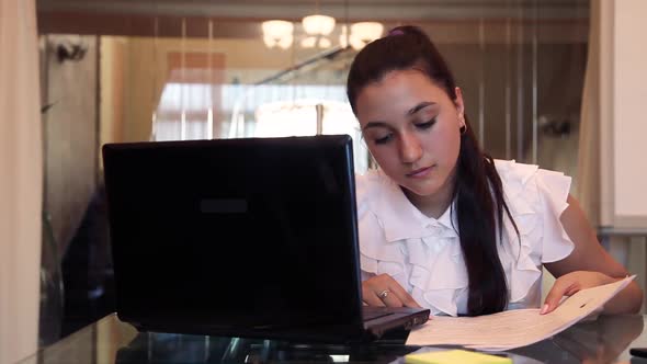 Business Girl is Experiencing Joy Throwing Documents Up in the Office While Sitting at the Table alt
