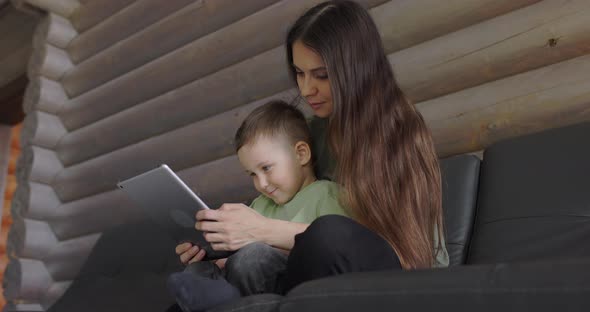 Happy Family Spending Time Together Exploring a New Educational App for Children alt