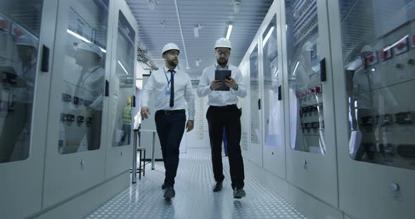 Diverse Colleagues Walking in Power Station Center alt