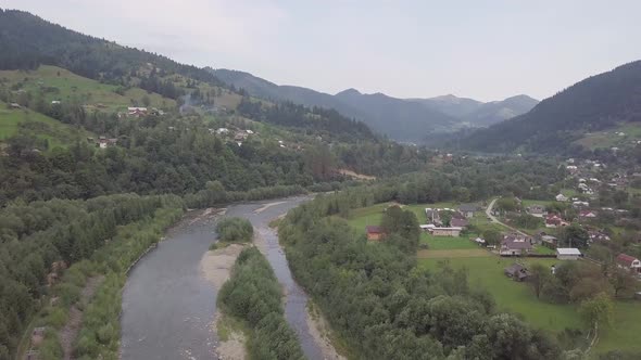 Aerial summer view to Carpathian village Kryvorivnia amidst mountains