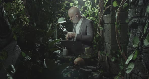 Stressed businessman working in the jungle