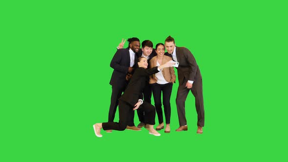 Young Colleagues Making Fast Selfie and Smiling on a Green Screen Chroma Key alt