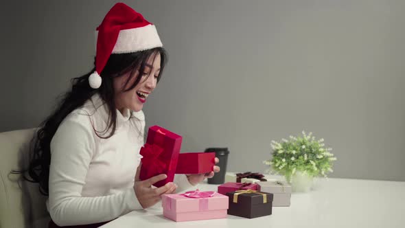 surprised woman in santa had opening Christmas gift box