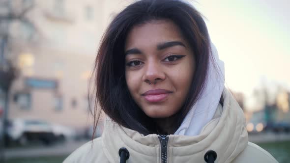 Happy Positive Latin Teenager Girl Smiling and Looking at Camera on the Street of Urban alt