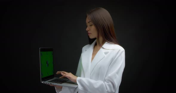 Asian Woman Typing on Laptop with Chroma Key and Showing Ok Sign