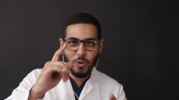 An African man laughs in surprise against a black background. Positive emotions alt
