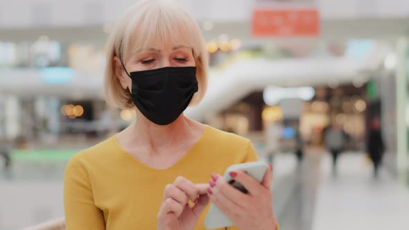 Mature Caucasian Woman in Protective Mask Walking Indoors Focused Serious Middleaged Businesswoman alt