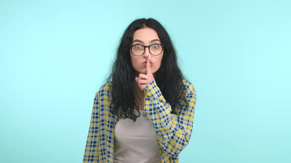 Angry Brunette Woman in Glasses Scolding Person Shushing and Telling to Be Quiet Press Finger to alt