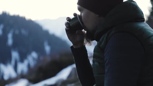 Bearded Man Drink Coffee in Winter Mountains alt