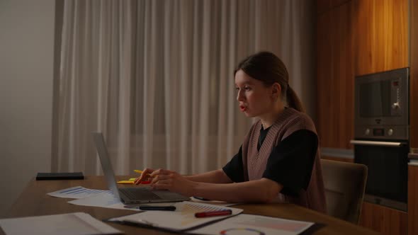 Mature Businesswoman Working From Home Focused Woman is Working with Her Laptop and Paper Documents alt