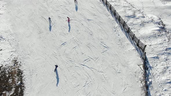 Skilled Athletes Ski on Wide Hill Slope Track with Fence alt