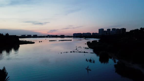 Man Ride on SUP Board in the Mountain Lake alt