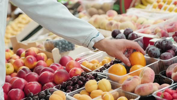 Unrecognizable Man Buying Fresh Fruit alt