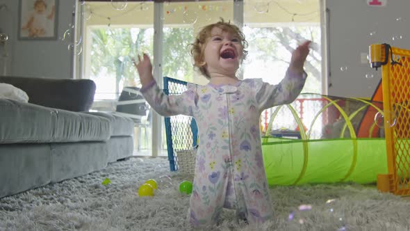 Beautiful Girl Playing with Bubbles at Home alt