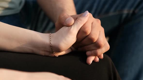 Close-up of the Hands of a Young Couple in Love
