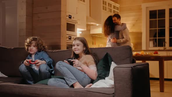 Children Actively Playing on Game Console Parents are Dancing at the Background alt