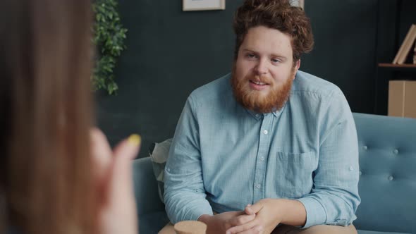 Male Patient and Female Therapist Discussing Problems Sitting in Comfortable Office alt