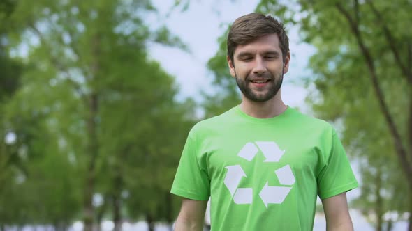 Handsome Man in Recycle Symbol T-Shirt Looking Camera, Environmental Protection alt