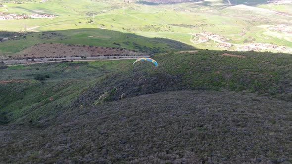 Para-glider Over the Top of the Mountain During Summer Sunny Day alt