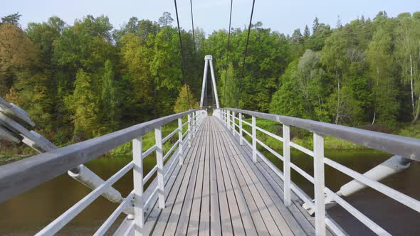 Suspension bridge over the river in autumn