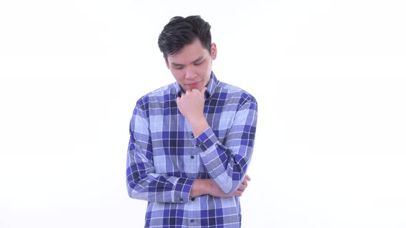 Stressed Young Asian Hipster Man Thinking and Looking Down alt