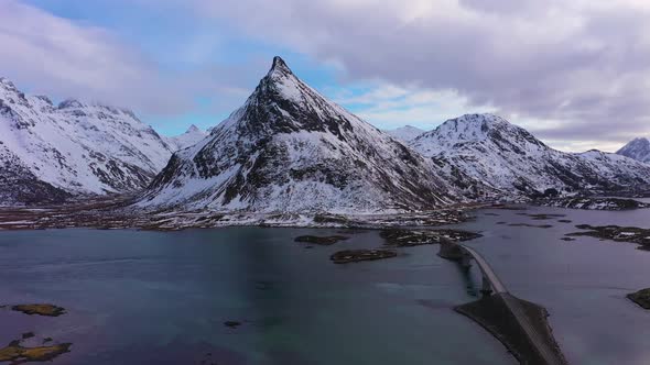 Fredvang Bridge and Volandstind Mountain in Winter. Lofoten, Norway. Aerial View alt