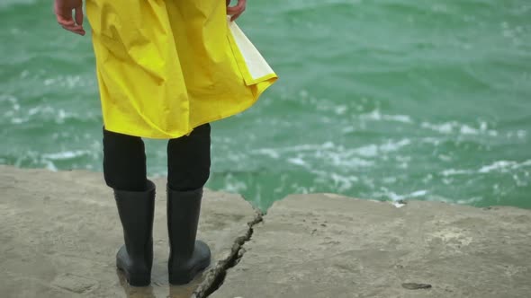 Person Standing Still on the Edge Pier Waves Dash Slomo alt