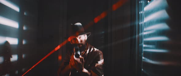 Man in lights of shutters and laser using vintage camera to record while smiling alt