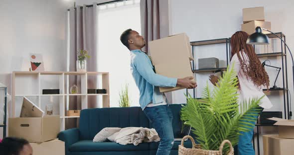 African American Holding Carton Boxes that Giving Him His Wife  alt