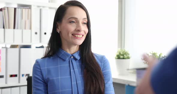 Female Leader Gives Trainee Manager Documents for Work alt