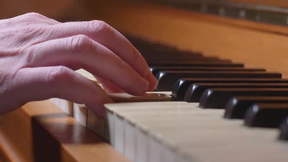 Dolly In On A Hand Playing One Chord On A Vintage Piano alt