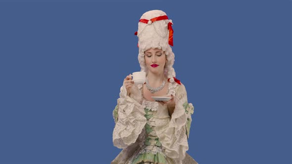 Portrait of Courtier Lady in White Vintage Lace Dress and Wig Drinking Coffee From a Cup alt