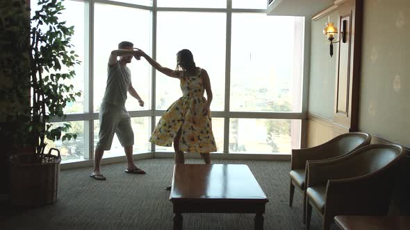 Dancing Couple Against Large Window