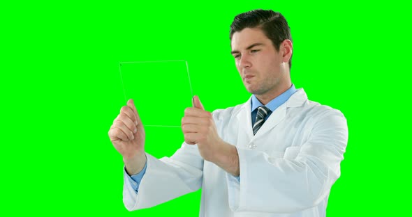 Doctor using futuristic tablet alt