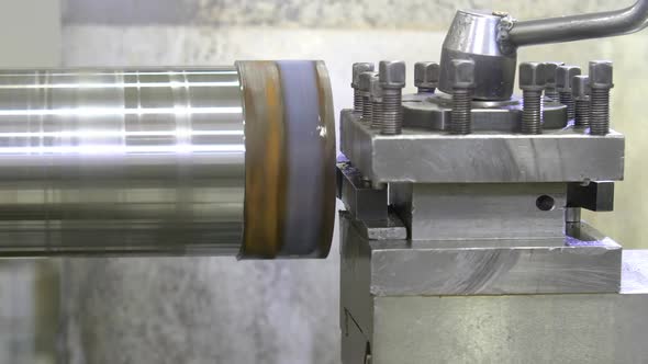 The Operation of Lathe Machine Cutting the Metal Shaft Parts