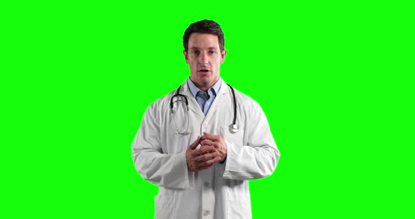 a Caucasian man wearing a surgeon blouse ans scrumbs in a green background