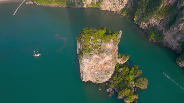 Separated Rock in the Sea Island As Limestone Cliff in the Blue Water Aerial alt